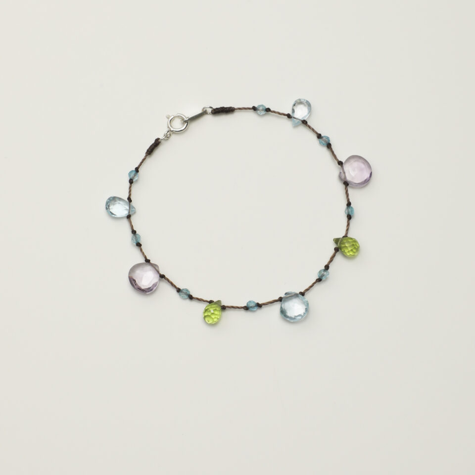 Topaz & Peridot Bracelet photographed on a pale background