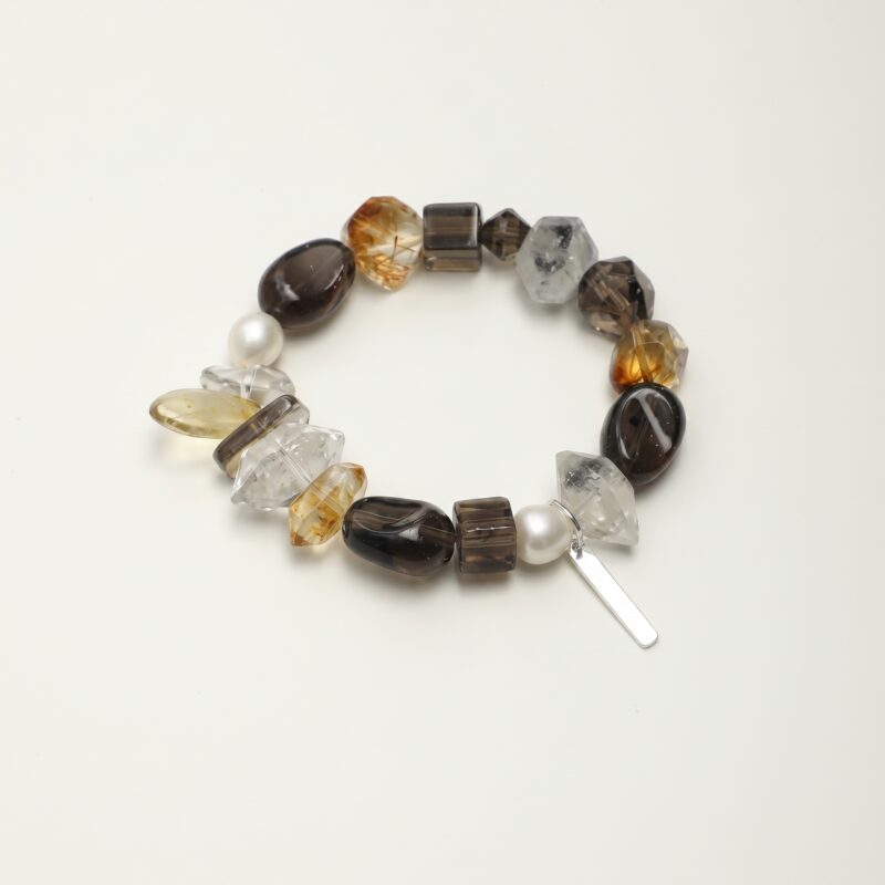 Clear Quartz, Smoky Quartz, Citrine & Cultured Pearl Bracelet photographed on a pale background