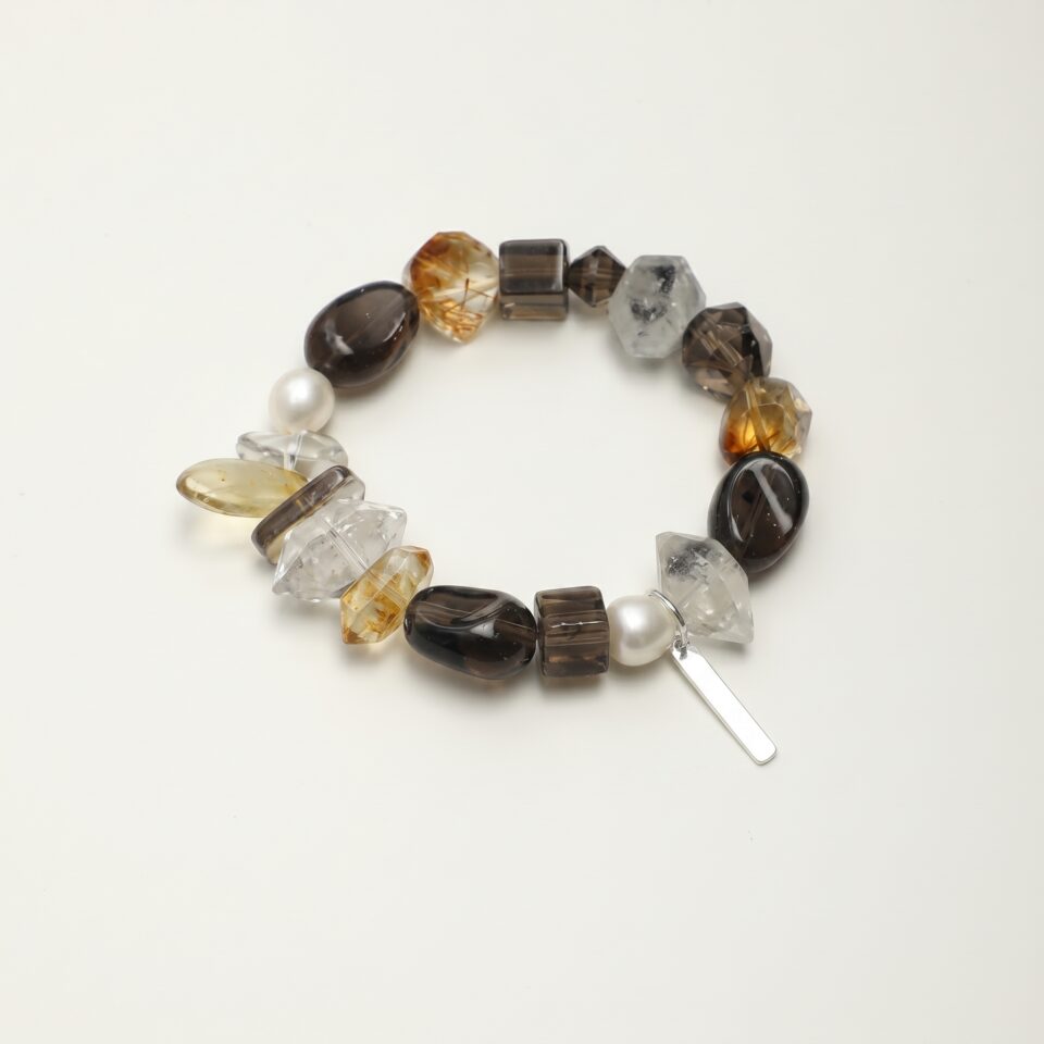 Clear Quartz, Smoky Quartz, Citrine & Cultured Pearl Bracelet photographed on a pale background