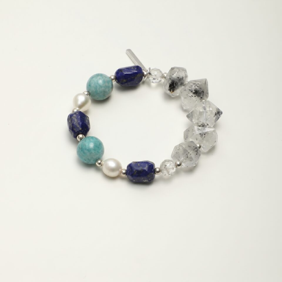 Lapis Lazuli, Amazonite & Cultured Pearl Bracelet photographed on a pale background