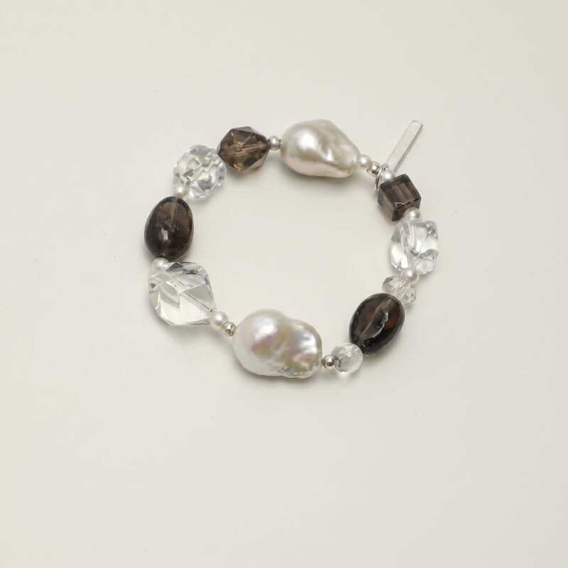Clear Quartz, Smoky Quartz & Cultured Pearl Bracelet photographed on a pale background