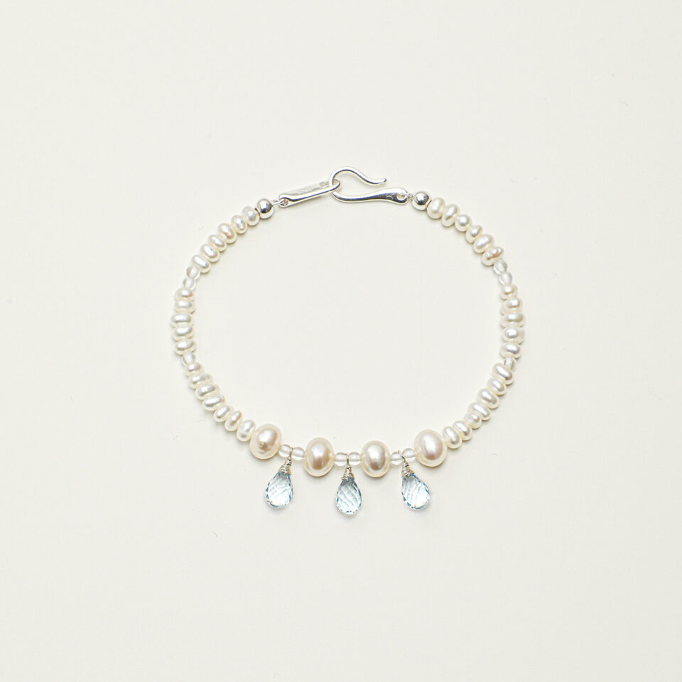 Clear Quartz, Topaz & Cultured Pearl Bracelet photographed on a pale background