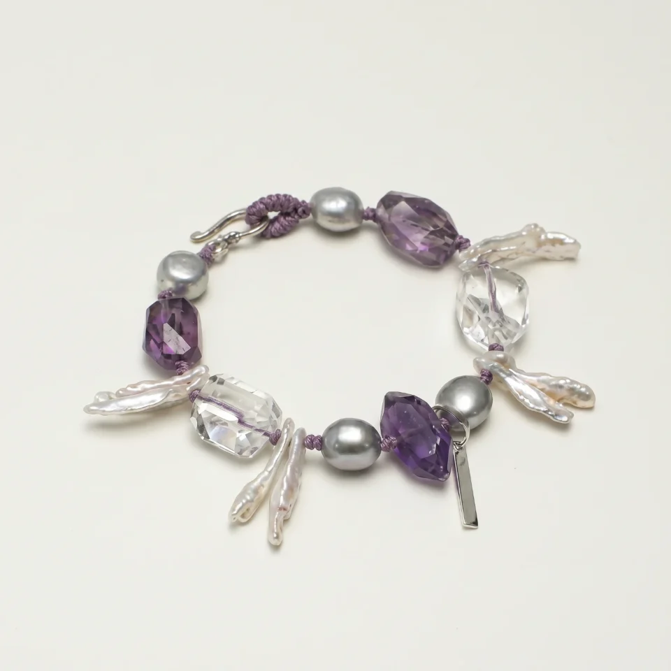 Clear Quartz, Amethyst & Cultured Pearl Bracelet photographed on a pale background