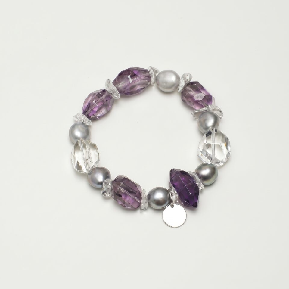 Clear Quartz, Amethyst & Cultured Pearl Bracelet photographed on a pale background