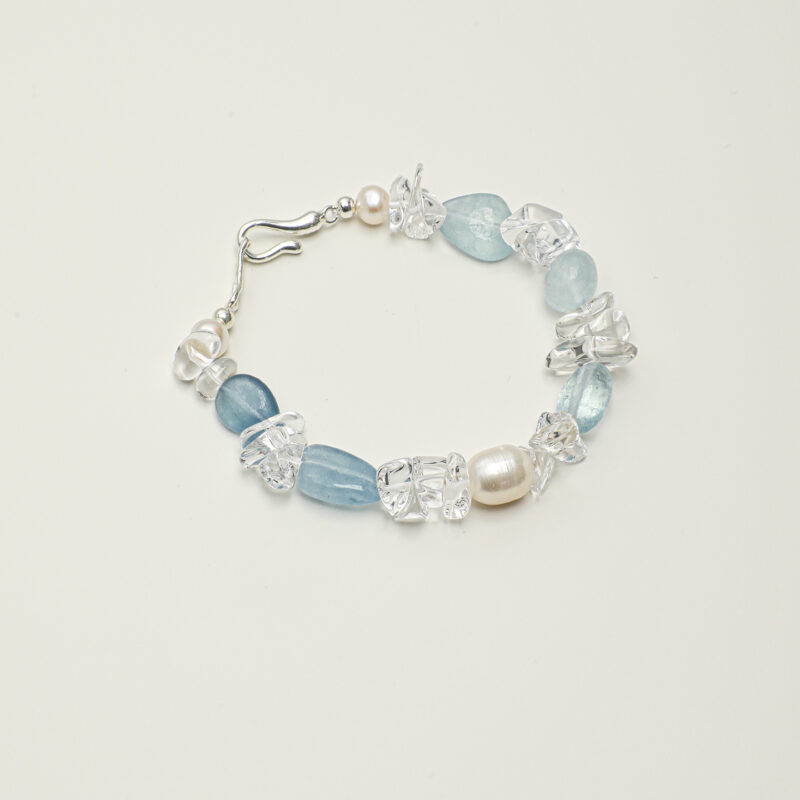 Clear Quartz, Aquamarine & Cultured Pearl Bracelet photographed on a pale background