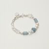 Clear Quartz, Blue Stone & Cultured Pearl Bracelet photographed on a pale background