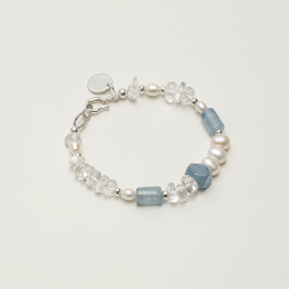 Clear Quartz, Blue Stone & Cultured Pearl Bracelet photographed on a pale background