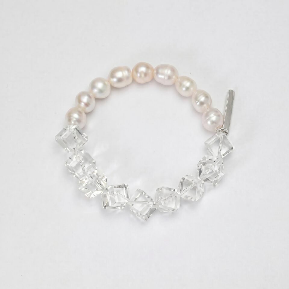 Clear Quartz & Cultured Pearl Bracelet photographed on a pale background