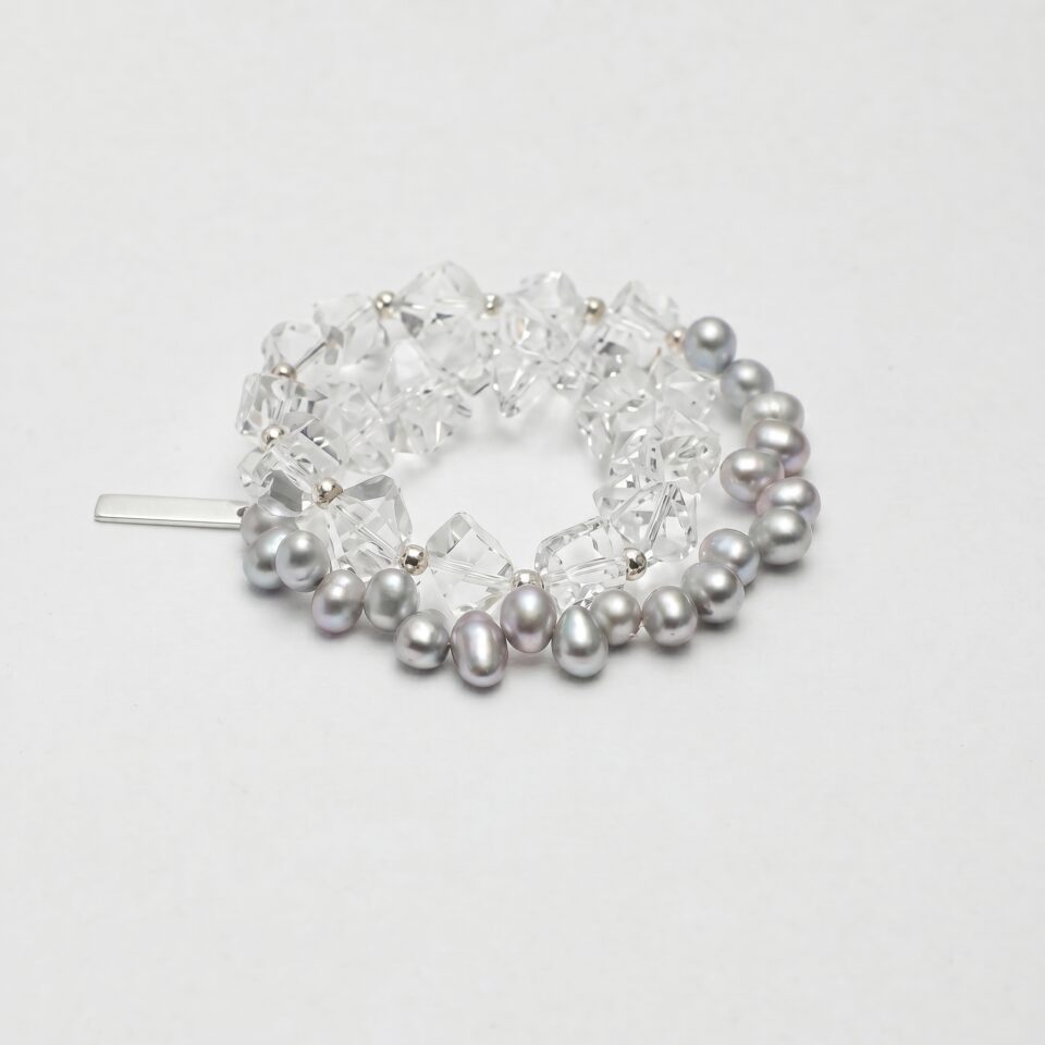 Clear Quartz & Cultured Pearl Bracelet photographed on a pale background