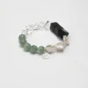 Agate, Aventurine & Cultured Pearl Bracelet photographed on a pale background